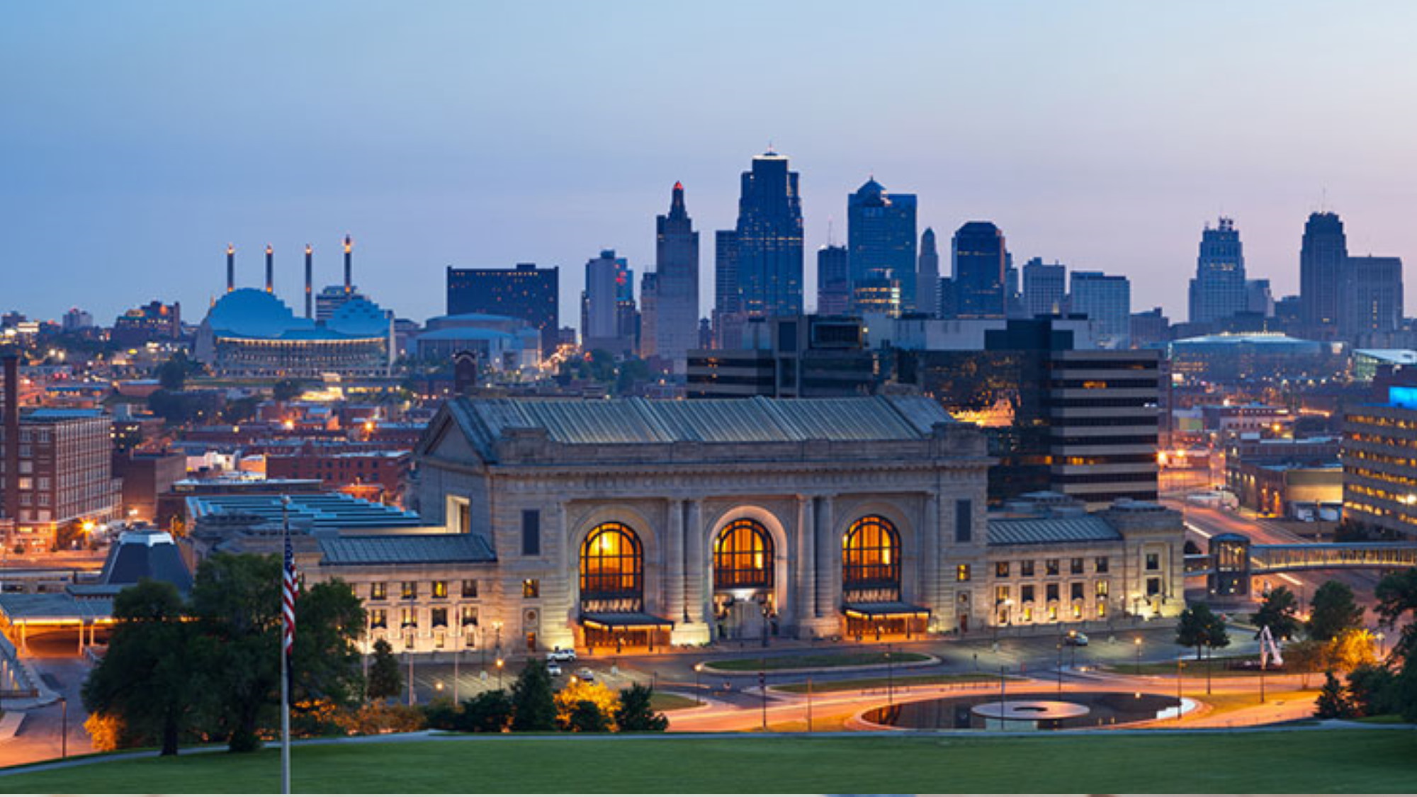 Couple sitting together on couch looking at laptop